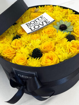 YELLOW MIXED FLOWERS - ROUND BLACK BOX CLOSED